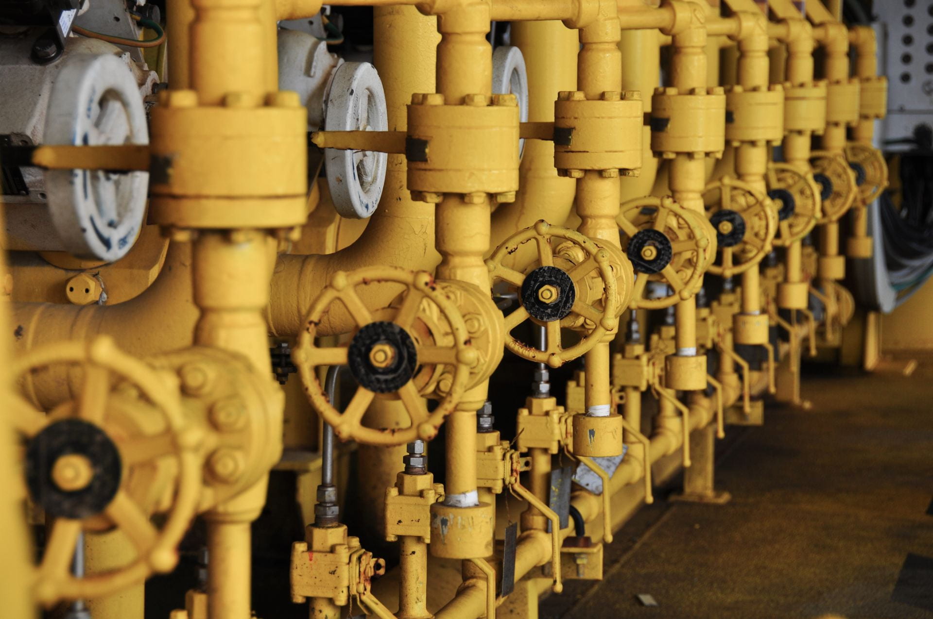 The image shows yellow pipes and valves